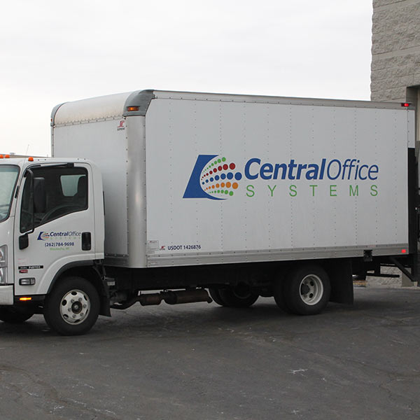 A company logo for "Central Office Systems" on the side of a small carrier truck.
